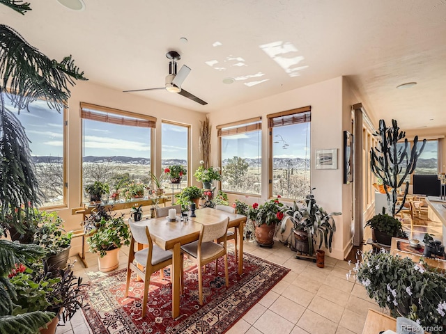 dining space featuring light tile patterned floors and a ceiling fan