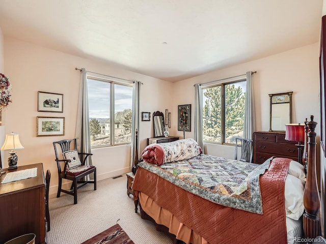 carpeted bedroom with visible vents and baseboards