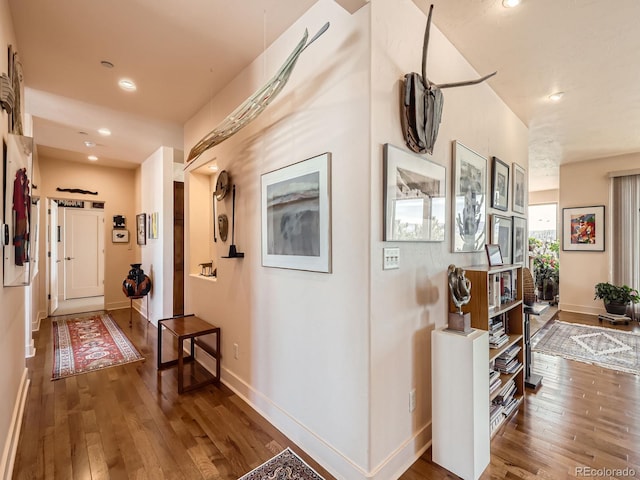 corridor with recessed lighting, baseboards, and hardwood / wood-style floors