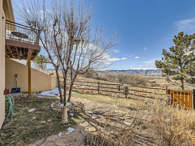 view of yard with fence and a mountain view