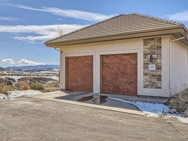 exterior space featuring a garage and a mountain view