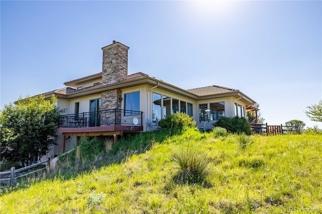 8611 Coachlight Way, Littleton, CO 80125 - back of house with stucco siding and a chimney