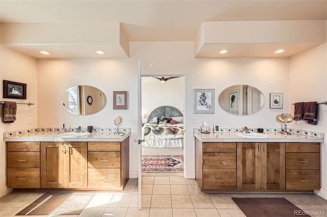 8611 Coachlight Way, Littleton, CO 80125 - ensuite bathroom featuring recessed lighting, two vanities, and tile patterned flooring
