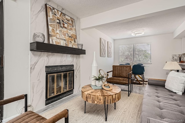 180 S Nome St, Aurora, CO 80012 - living room with a textured ceiling, a fireplace, and wood finished floors