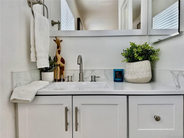 180 S Nome St, Aurora, CO 80012 - bathroom featuring vanity and backsplash