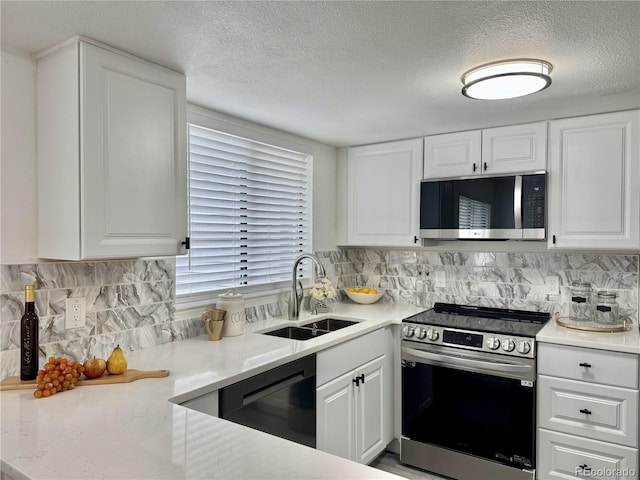 180 S Nome St, Aurora, CO 80012 - kitchen featuring stainless steel appliances, a sink, a textured ceiling, and white cabinetry