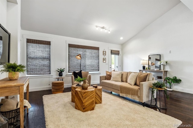 living room featuring vaulted ceiling, hardwood / wood-style flooring, baseboards, and recessed lighting