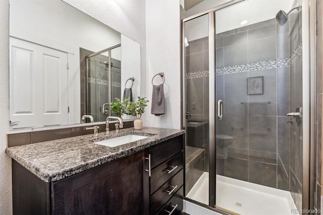full bath featuring a shower stall and vanity