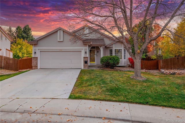 view of front of home with a yard and a garage