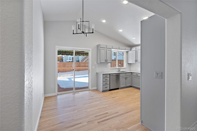 kitchen featuring gray cabinetry, sink, pendant lighting, dishwasher, and light hardwood / wood-style floors