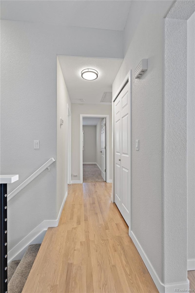 corridor with light wood-type flooring