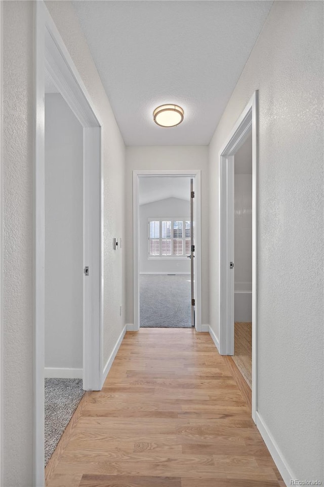 corridor with light wood-type flooring