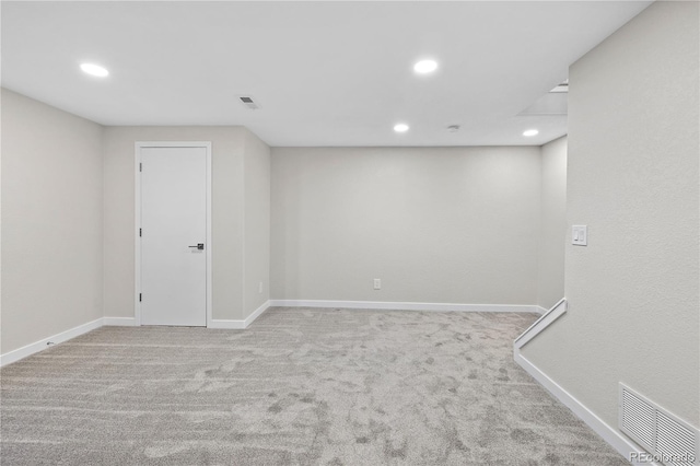 basement featuring light carpet