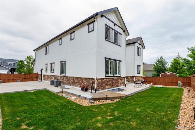 690 W 172nd Pl, Broomfield, CO 80023 - rear view of property featuring a patio, stone siding, and a fenced backyard