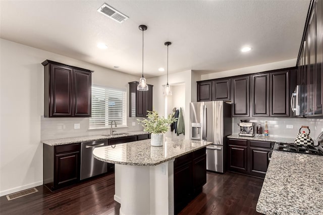 690 W 172nd Pl, Broomfield, CO 80023 - kitchen featuring stainless steel appliances, dark wood-style flooring, dark brown cabinetry, and recessed lighting