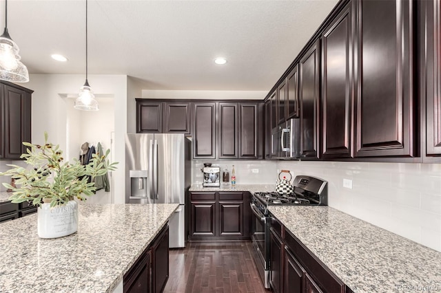 690 W 172nd Pl, Broomfield, CO 80023 - kitchen featuring stainless steel appliances, dark brown cabinetry, light stone countertops, decorative light fixtures, and recessed lighting
