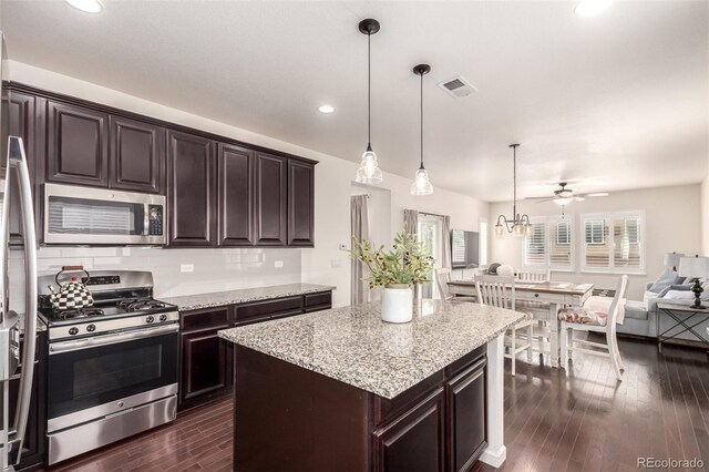 690 W 172nd Pl, Broomfield, CO 80023 - kitchen with stainless steel appliances, open floor plan, plenty of natural light, dark wood finished floors, and recessed lighting