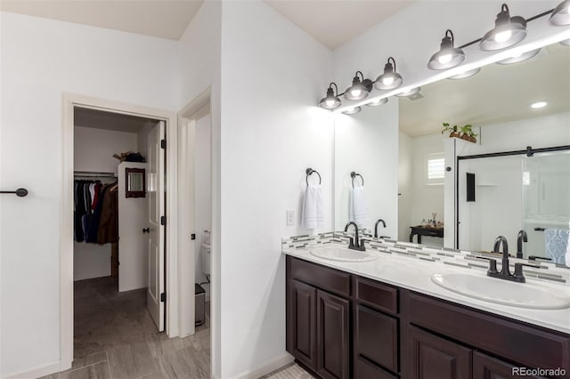 690 W 172nd Pl, Broomfield, CO 80023 - full bath featuring double vanity, a spacious closet, and a shower stall