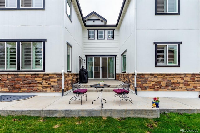 690 W 172nd Pl, Broomfield, CO 80023 - back of property featuring stone siding and a patio area