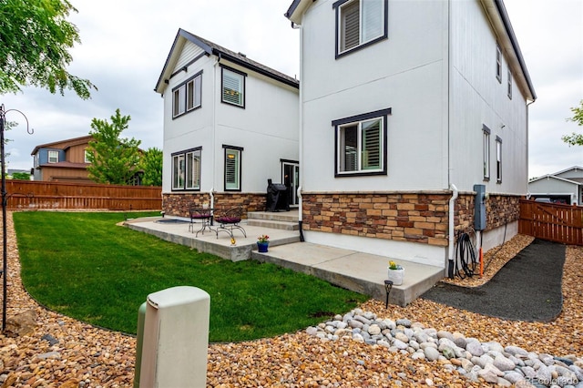 690 W 172nd Pl, Broomfield, CO 80023 - rear view of property with stone siding, a fenced backyard, and stucco siding