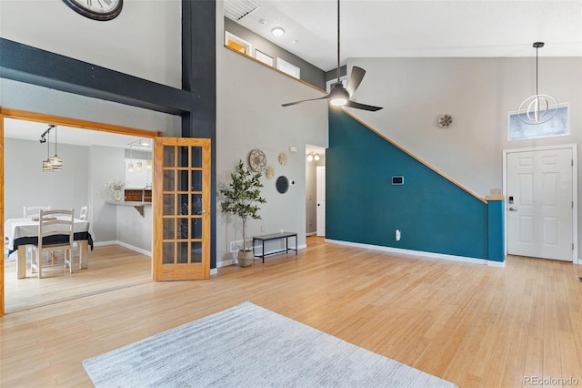 entryway with hardwood / wood-style floors, ceiling fan, and high vaulted ceiling