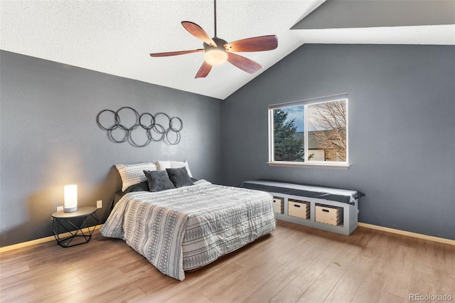 bedroom featuring ceiling fan, wood-type flooring, and vaulted ceiling