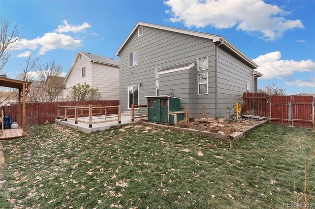 rear view of house featuring a yard