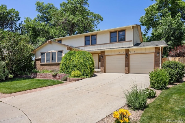 9025 Jellison Ct, Broomfield, CO 80021 - view of front of house with brick siding, concrete driveway, and board and batten siding