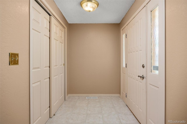 9025 Jellison Ct, Broomfield, CO 80021 - foyer entrance with a textured ceiling and light tile patterned floors