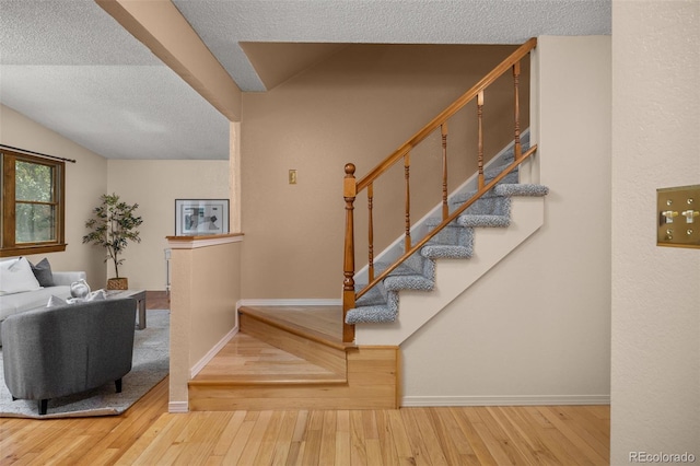 9025 Jellison Ct, Broomfield, CO 80021 - staircase with a textured ceiling and hardwood / wood-style flooring