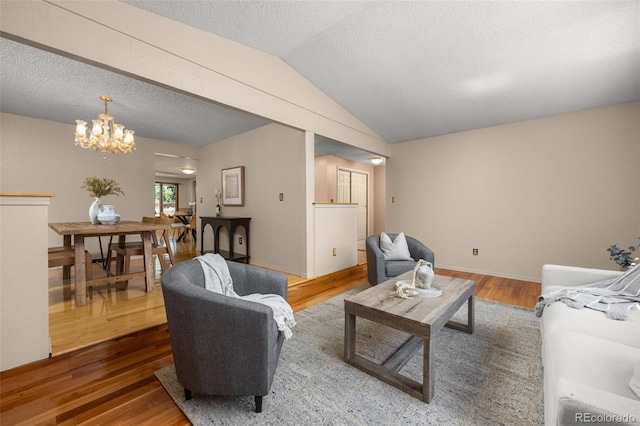 9025 Jellison Ct, Broomfield, CO 80021 - living room featuring wood finished floors, a chandelier, lofted ceiling, and a textured ceiling