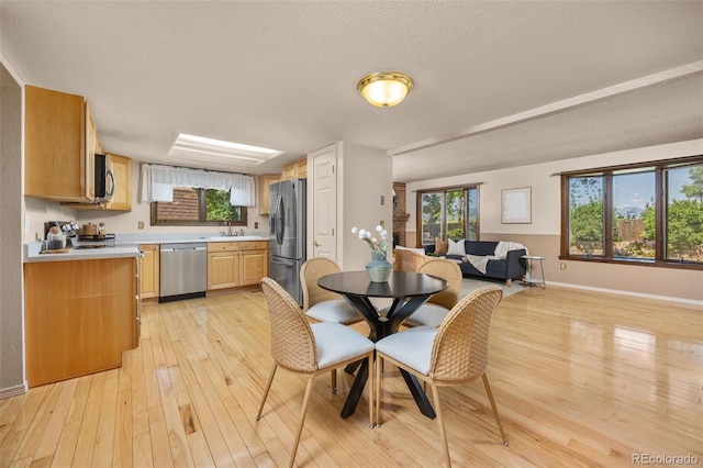 9025 Jellison Ct, Broomfield, CO 80021 - dining area with light wood-style floors and a textured ceiling