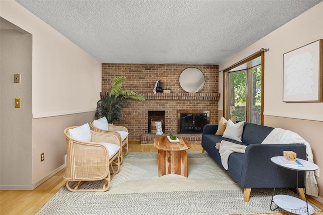 9025 Jellison Ct, Broomfield, CO 80021 - living room featuring a textured ceiling, wood finished floors, and a brick fireplace