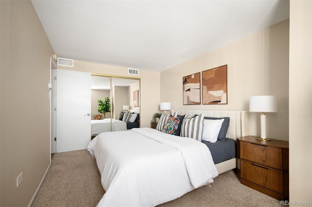carpeted bedroom featuring a closet and visible vents