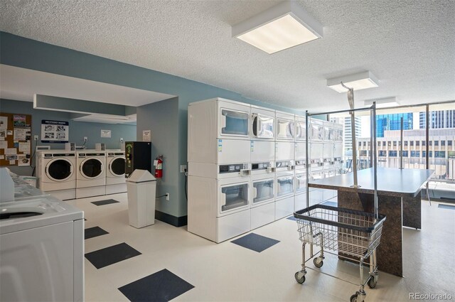 shared laundry area with stacked washer and clothes dryer, a textured ceiling, and washer and dryer