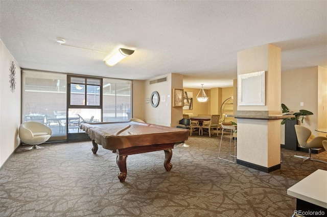 rec room featuring floor to ceiling windows, a textured ceiling, dark carpet, and pool table
