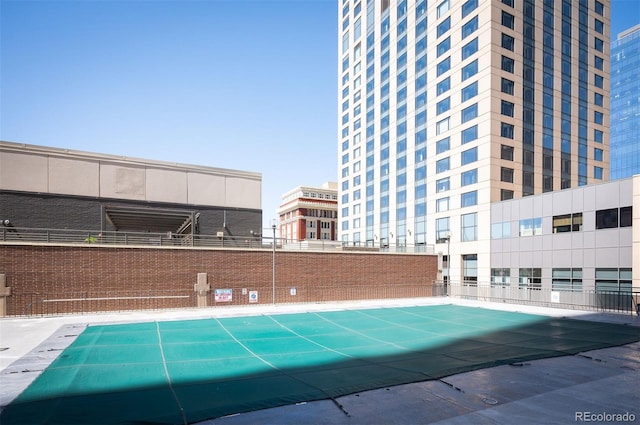 view of pool featuring fence