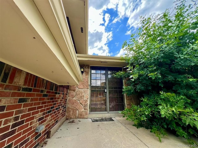 7245 S Dexter St, Centennial, CO 80122 - entrance to property featuring a patio and stone siding