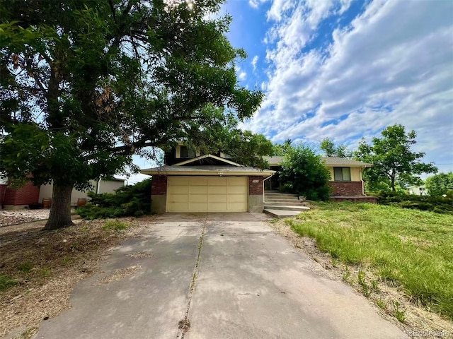 7245 S Dexter St, Centennial, CO 80122 - obstructed view of property with concrete driveway, brick siding, and a garage