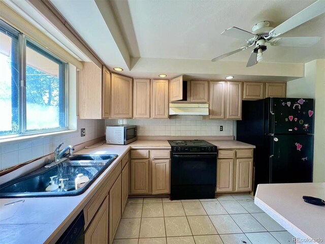 7245 S Dexter St, Centennial, CO 80122 - kitchen featuring black appliances, under cabinet range hood, light countertops, light tile patterned floors, and tasteful backsplash