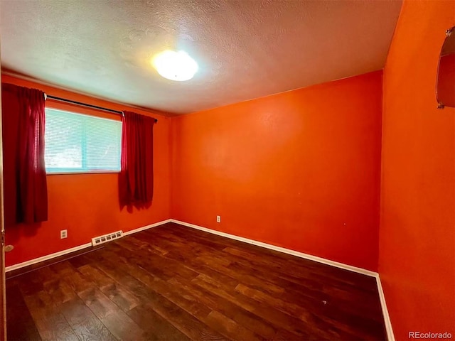 7245 S Dexter St, Centennial, CO 80122 - spare room featuring wood finished floors and a textured ceiling