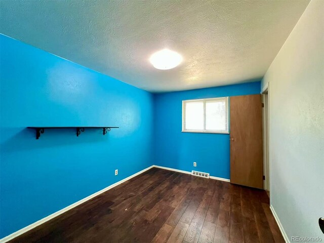 7245 S Dexter St, Centennial, CO 80122 - unfurnished room with hardwood / wood-style flooring and a textured ceiling