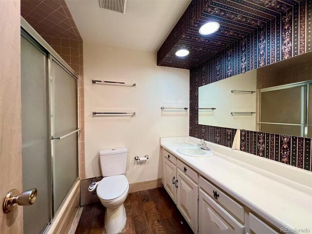 7245 S Dexter St, Centennial, CO 80122 - bathroom with wood finished floors, vanity, and shower / bath combination with glass door