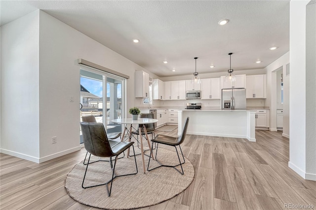 dining space featuring light wood-type flooring