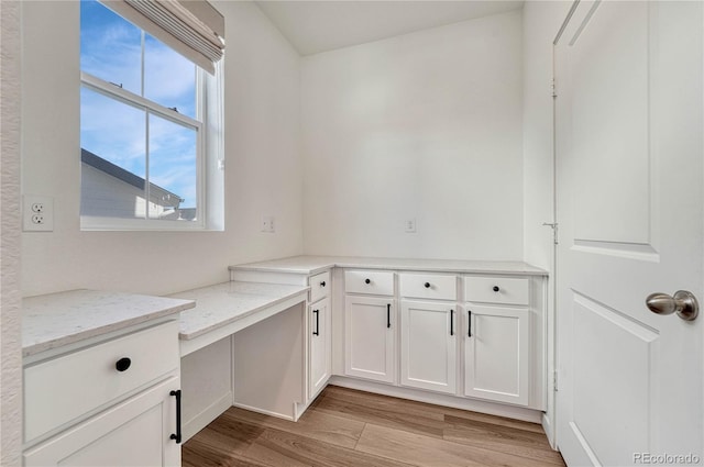 unfurnished office with light wood-type flooring