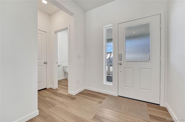 foyer entrance with light hardwood / wood-style flooring