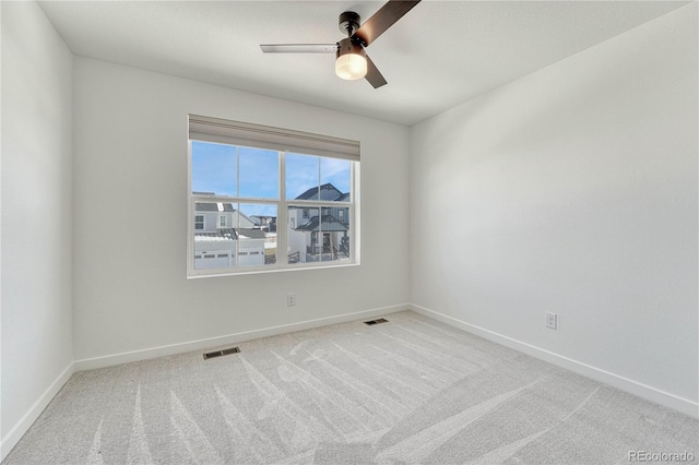 empty room with light colored carpet and ceiling fan