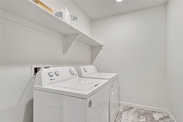 clothes washing area featuring separate washer and dryer