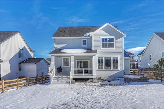 snow covered property with a porch