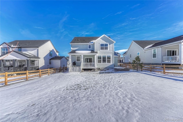 snow covered property featuring a porch